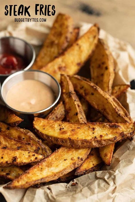 These incredibly crispy, thick cut, oven baked steak fries are seasoned to perfection with steak seasoning for maximum flavor in every bite! Budetbytes.com Baked Steak Fries, Steak Fries Recipe, Recipe Background, Oven Baked Steak, Fried Steak Recipes, Steak In Oven, Baked Steak, Potato Wedges Recipe, Dinner Favorites