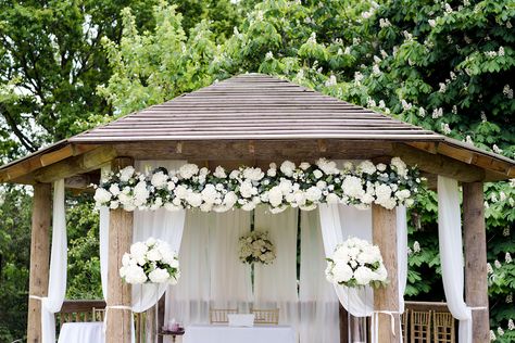 Beautiful flowers and drapes on our outdoor wedding gazebo by Designer Flowers Essex last summer.  Photo by Jasmine Jade Photographyy. Outdoor Wedding Canopy Ideas, Outdoor Wedding Gazebo Decor, Gazebo Ideas Wedding Outdoor, Backyard Gazebo Wedding, Gazebo With Flowers, White Gazebo Wedding, Flower Gazebo Wedding, Wedding Gazebo Decorations, Gazebo Drapes Wedding