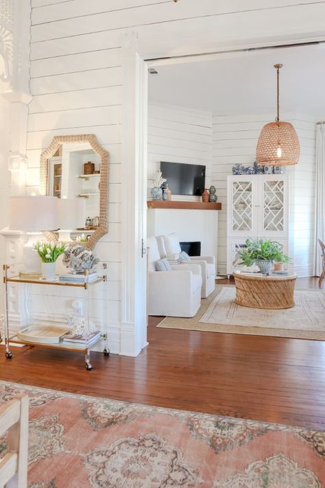 Farmhouse Living | Interior Design | Home Tours | Home Design | Coastal Cottage | White Shelves | Neutral Textiles | Pendant Lights | Woven Baskets | Primary Kitchen | Primary Dining Room | Primary Living Room | Woven Chairs | Neutral Colors | Light Fixtures | Gold Accents | Kitchen Range | Shiplap Walls | Bamboo Shades | Warm Vintage Rugs | Dining Room With Shiplap Accent Wall, Coastal Living Room Rug Ideas, Boho Light Living Room, Southern Coastal Cottage, Airy Cottage Interior, Quaint House Interior, Coastal Piano Room, Bright And Airy Dining Room, Colorful Coastal Cottage