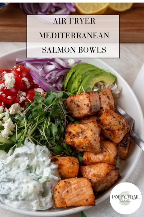 A large shallow bowl holds air fryer Mediterranean salmon bowls. The dish is garnished with bright vegetables and tzatziki sauce.  A wooden board with more chopped vegetables sit near the bowl. Salmon Tzatziki Bowl, Air Fryer Salmon Salad, Mediterranean Salmon Bowl, Salmon Tzatziki, Salmon Cottage Cheese, Tzatziki Bowl, Cottage Cheese Bowl, Cheese Bowl, Salmon Bowls