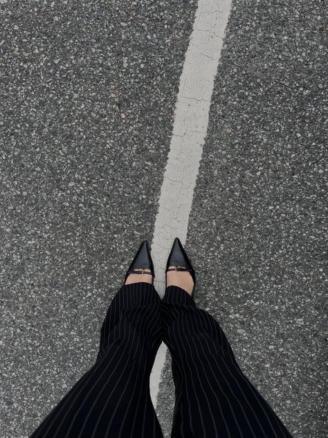 Black slingback shoes. Pointy black leather shoes for woman. Pinstripe pants. Standing on the pavement on a parking lot. Pointy Shoes Outfit, Shoes For Woman, Pointy Shoes, Fall 23, Pinstripe Pants, Pinstripe Suit, Slingback Shoes, Black Leather Shoes, Suit Pants