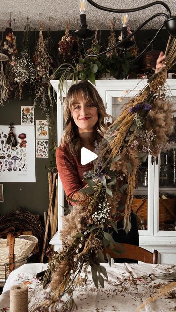 Cassandra Evans (Sunny) // Folk Living on Instagram: "How to make a flora garland 🌾🥀

Here are the instructions, but I’ll also be uploading a full length tutorial on my a YouTube channel soon, so make sure you’re subscribed for that!

To start, you’ll want to gather lots of beautiful dried florals - grasses, blooms, leaves, etc.

Cut a piece of sturdy twine the length of your garland. This will be the “backbone.” Gather a bundle of flora and tie into the end of the twine very tightly with a double knot. Gather another bundle and layer on top of the other, tying onto the “backbone” piece with a separate pice of twine. Continue doing this until you reach the middle, then start again going up the other side.

Once you reach the middle, create a bundle that goes both directions, and again se Dried Floral Garland, Dried Flower Garland, Dried Florals, Double Knot, Start Again, Floral Garland, Dried Floral, Grasses, The Other Side