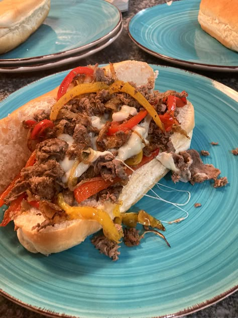 A long submarine roll holds sauteed steak, peppers, onions and cheese on a turquoise plate. Sloppy Joe Grilled Cheese, Quick Steak, Sandwich Tuna, Lemon Sauce For Chicken, Shaved Beef, Sandwiches For Dinner, Tuna Fish Sandwich, Sauteed Steak, New England Recipes