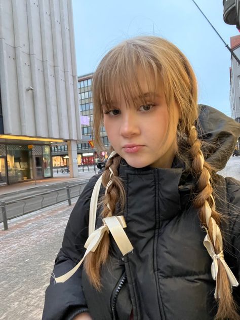 Girl with bangs and ribbon hairstyle, outside in the winter Pigtail Braids With Bangs, Lace Ribbon Hairstyles, Double Braids With Ribbon, Two Ponytails With Ribbon, Braided Pigtails With Bangs, Bangs With Two Braids, Ribbon Headbands Hairstyle, Fish Tail Braids Hairstyles, Ribbon Braid Hairstyle