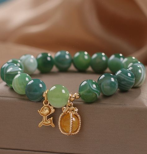 Deer means health and love. It brings happiness and longevity. is a symbol of love. Green agate represents health and vitality. It can promote blood circulation, relieve tension, bring hope and make people full of self-confidence. Keep this stunning bracelet close to discover the peaceful energy of agate in your life. Natural green agate Bead ... #Unveiling #HandmadeJewelry #Exploring #the #of #Accessories #Natures #Beauty #JewelryAddict #Allure #Fashion #Gemstone #Jewelry #of #the #Treasures Green Agate Bracelet, Green Gemstone Bracelet, Peaceful Energy, Health And Vitality, Green Bracelet, Symbol Of Love, Beads Bracelet Design, Crystal Tiaras, Agate Bracelet