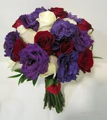 Rich jewel tones of red and purple are accented with ivory in this bridal bouquet featuring roses and lush lisianthus. Red Purple Wedding, Purple Bridal Bouquet, Mississippi Wedding, Red Wedding Theme, Purple Wedding Bouquets, Red Bouquet Wedding, Wedding Colors Purple, Red Wedding Flowers, Red Bouquet