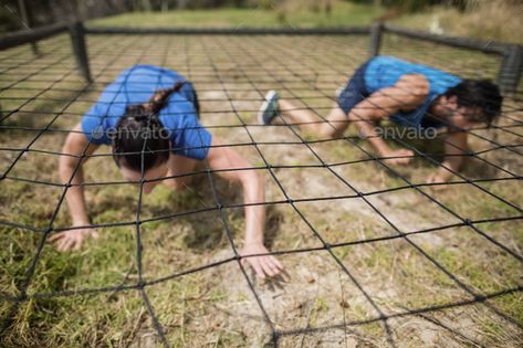 Fit man and woman crawling under the net during obstacle course by Wavebreakmedia. Fit man and woman crawling under the net during obstacle course in boot camp #Affiliate #woman, #crawling, #Fit, #man Army Obstacle Course, Woman Crawling, Zombies Run, Fitness Trail, Fit Man, Mud Run, Spartan Race, Playground Design, Amazing Race