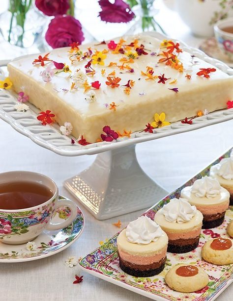 Who doesn't enjoy a dreamy piece of cake with a cup of tea? This one-layer Coconut Cake with White Chocolate Ganache—pictured with Neapolitan Cheesecakes, and Apricot-Orange Thumbprint Cookies—is sure to be a delightful treat to enjoy this weekend, especially while sipping Mark T. Wendell Tea Company's "Extra Fancy Formosa Oolong." Find the recipe at https://bit.ly/3gCB1PJ Garden Tea Party Food, White Chocolate Ganache Recipe, Tea Sweets, Square Cake Stand, Cake With White Chocolate, Tea Time Food, Apricot Orange, Ganache Recipe, White Chocolate Ganache