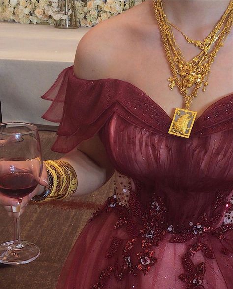 Beautiful wine red dress with stunning gold jewellery !! Red Dress Gold Accessories Prom, Red Dress And Gold Accessories, Red Gold Prom Dress, Red Rose Prom Dress, Red Dress With Gold Accessories, Red And Gold Clothes, Royal Red Dress Aesthetic, Red And Gold Dress Aesthetic, Gold And Red Outfit