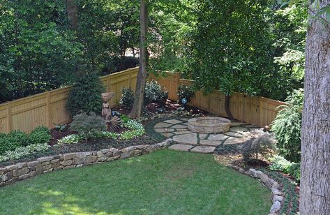 Drainage was a huge problem in this yard. Water from the five lots on the upper side of the house drained down the driveway, creating a "river" when it rained. Landscape Studio put in two catch basins and an earth berm to stop the water. We re-graded the backyard and installed a dry creek bed to redirect the water. Landscape Studio designed a privacy fence, planted annuals and perennials, added a raised planter for vegetable gardening, and found the perfect spot in this beautiful yard… Landscaping Along Fence, Backyard Drainage, Mailbox Landscaping, Dry Creek Bed, Water Landscape, Creek Bed, Raised Planter, Rock Garden Landscaping, Fence Landscaping