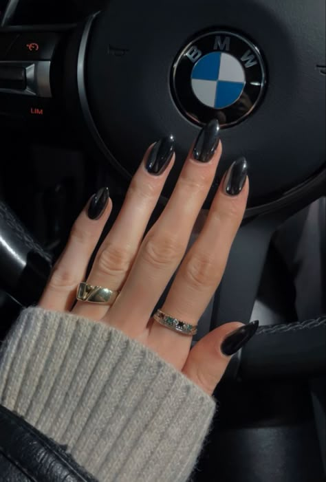 In this picture you can see a hand with rings, held in front of a BMW steering wheel.  The person is wearing a beige sweater and a leather jacket , the hand has black chrome nails. Chrome Nails With Black, Black Nails With Metallic, Black Nails Chrome Design, Metallic Nails Gel, Nails Black Metallic, Black Chrome Acrylic Nails, Crome Nails Black, Black With Crome Nails, Black Chrome Nails Almond Short