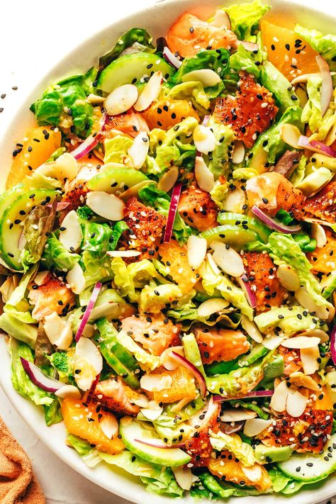 This orange salmon salad recipe is tossed with avocado, cucumber, red onion, toasted almonds, Romaine and drizzled with an irresistible ginger hot honey vinaigrette. It's the perfect sweet and savory entrée salad when you're craving a healthy dinner and it's naturally gluten-free as well. | gimmesomeoven.com Salmon Salad Recipe, Honey Vinaigrette, Salmon Salad Recipes, Orange Salmon, Gimme Some Oven, Pan Seared Salmon, Hot Honey, Vinaigrette Recipes, Salmon Salad