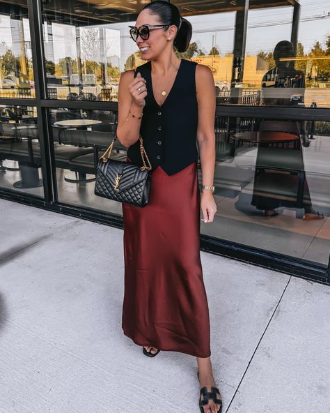 Effortlessly Chic: How to Style a Vest and Satin Dress for an Elevated Look Love this look? Shop each piece and recreate this elevated style through my LTK! Tap the link in bio to explore more outfit inspo. https://liketk.it/4Sy2E chic, versatile outfit, black button-up vest, satin skirt—elevated style, comfortable outfit, timeless style, YSL bag, black slides, classic outfit, Aritzia #aritziaoutfits #vestoutfit #autumnoutfitinspo #ltkfall Vest And Skirt Outfits For Women, Black Vest And Skirt Outfit, Button Vest Outfits, Slip Skirt Outfit Fall, Vest And Skirt Outfit, Vest Dress Outfit, Style A Vest, Dress With Shirt Underneath, How To Style A Vest