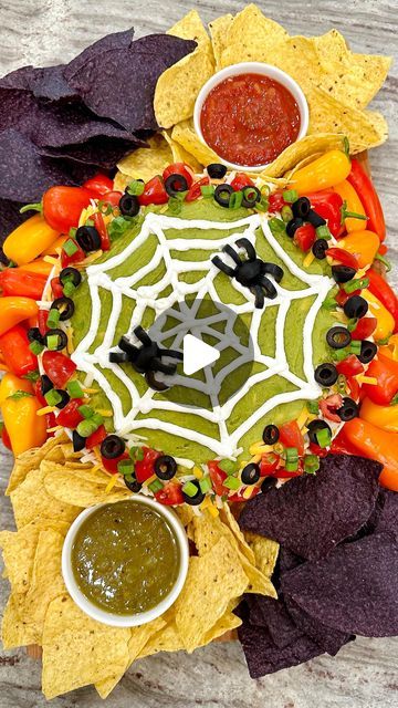 Maegan Brown ~ The BakerMama on Instagram: "Spiderweb Seven Layer Dip Board 🕸️🕷️ COMMENT “recipe” and I’ll send you the details! Seven layers of deliciousness with a spooky cute design on top makes for the perfect Halloween party appetizer! Such an easy way to serve up something creative.   With beans on bottom, followed by salsa, spiced sour cream, sliced black olives, chopped green onions, cheese, and guacamole, it’s layer upon layer of yumminess. Dip into it with your favorite chips and veggies (I put mini peppers on the board this time, but carrots, celery and cucumbers would be great dippers for this board, too). I also added a few salsas on the side.  https://thebakermama.com/recipes/spiderweb-seven-layer-dip-board/  #sevenlayerdip #spiderweb #snackboard #halloween #halloweensnacks Halloween Salsa Ideas, Halloween Artichoke Dip, Spiderweb Guacamole, Halloween Chips And Dip, Halloween Guacamole, Dip Board, Mini Peppers, Halloween Party Appetizers, Seven Layer Dip