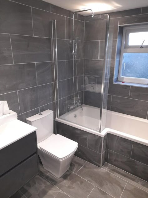 Small L Shaped Bathroom Ideas, Fully Tiled Small Bathroom, Grey En Suite Bathroom, Grey En Suite Bathroom Ideas, Dark Grey Bathroom Tiles Walls, Small Bathroom L Shaped Bath, Corner Bath Tiling Ideas, Shower Ideas Bathroom Master Baths, Dark Grey Tile Bathroom