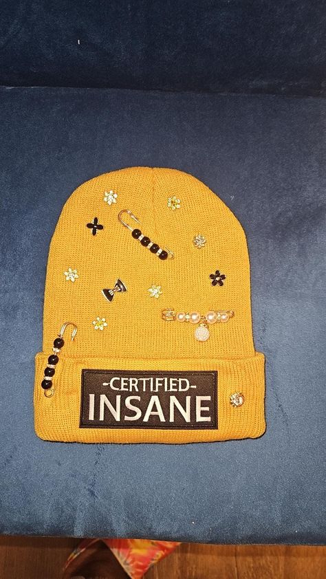 Certified insane junk beanies for the winter Junk beanie for any occasion.  adult size. 
please be aware stones are not sewn on so it is a possibility that stones and charms may pop off. in this event you can glue charms and stones back on. Pins can be rearranged and moved. 

charms are chosen at random. no special requests

no item is alike. may be similar but not identical. Diy Beanie Hat, Diy Beanie, Beacon Ny, Hat Jewelry, Skull Cap Beanie, Skull Cap, Winter Hat, Beanie Hat, Custom Items