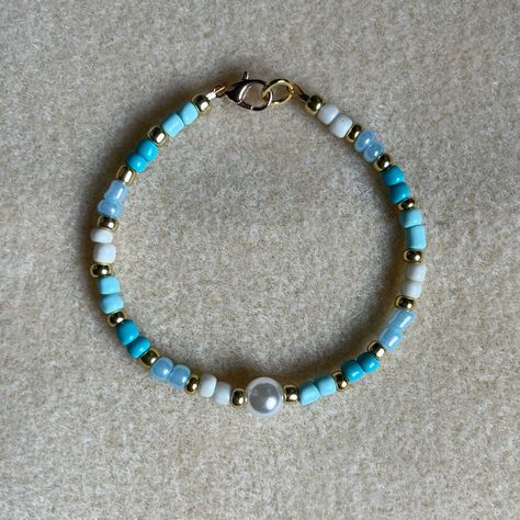 - One Of A Kind Beaded Bracelet - Featuring Light Blue, White, And Gold Seed Beads With A White Pearl Bead At The Center - Gold Colored Hardware - Clasps Closed. No Stretch. - Size/ Circumference Is 7” - Handmade (By Myself). Perfect To Treat Yourself Or To Give As A Unique Gift! **Add 2 Jewelry Items Marked “2 For $20” To Your Bundle And I Will Send You An Offer For $20** Tags: Beaded, Handmade Jewelry, Colorblock, Ocean, Pearls Check Out The “Boutique” Tab In My Closet For Handmade Earrings, B White And Blue Beaded Bracelet, Blue Seed Bead Bracelet Ideas, Clay And Seed Bead Bracelet, Blue Handmade Bracelet, Anklet Ideas Clay Beads, Cute Bracelet Patterns Beads, Simple Bracelets Diy Beads, Blue Bead Bracelet Ideas, Bracelet Seed Beads Ideas