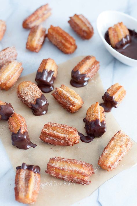 Cinnamon Mini Churros . Have you tried a real churro? Not the long, freeze and bake churros they sell at theme parks, carnivals, or malls. I mean freshly fried, made from scratch kind of churros. If your answer is no then you have to make these simple and easy churro recipe!!! Crispy on the outside, chewy in the middle. Covered in cinnamon sugar. #churro #mini #miniChurro #chocolateDipped #chocolate #cinnamonSugar Churros Bites Recipe, Cuban Sweets, Easy Churro Bites, Churreria Ideas, Making Churros, Cinnamon Churros, Churro Recipe, Easy Churros, Party Snack Ideas