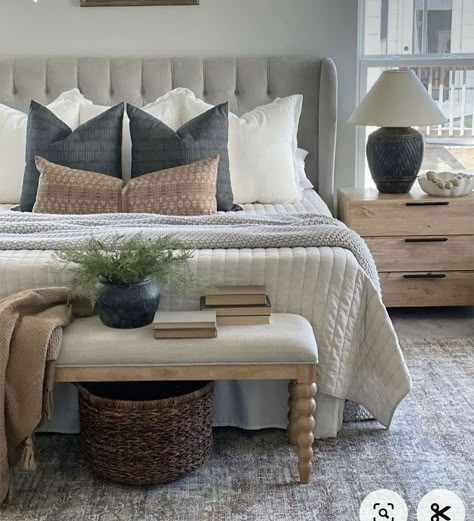 Transform your bedroom into a cozy farmhouse retreat with layered textures and neutral tones. The focal point is a plush, tufted headboard in a soft gray, complementing the neutral color scheme. The layering of pillows on the bed adds depth and comfort to the space. The overall color palette is soft and neutral, creating a serene and restful environment. #FarmhouseBedroom #CozyLiving #InteriorDesign #HomeDecor Bedrooms Decor, Bedroom Refresh, Master Bed, Primary Bedroom, Remodel Bedroom, Master Bedrooms Decor, Master Bedrooms, Main Bedroom, Guest Bedrooms