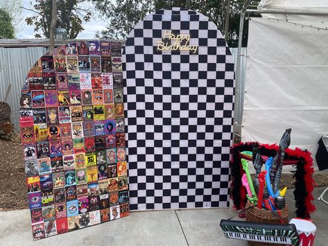 Poster board and checkered backdrop with props 🎸 Rock N Roll Party Aesthetic, 1st Birthday Rockstar Theme, Rock N Roll Backdrop, Warped Tour Themed Party, Vinyl Record Backdrop, Rock And Roll Backdrop, Motley Crue Birthday Party Theme, Punk Party Ideas, Rick And Roll Party Ideas