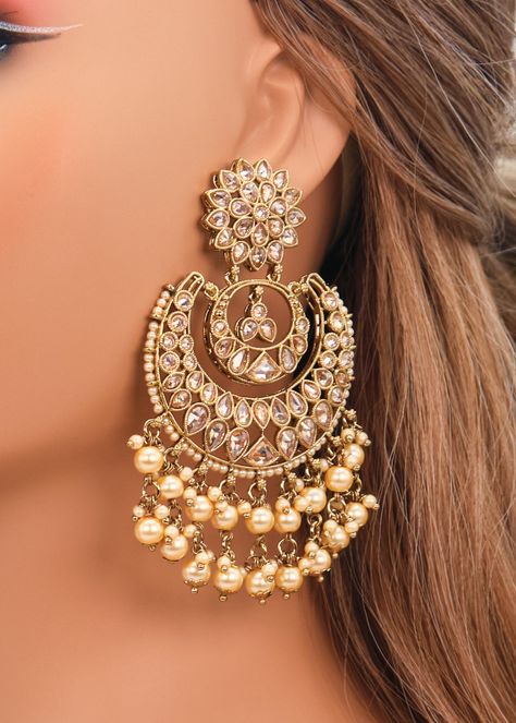 These Polki earrings are a classic addition to any traditional outfit with their stunning stones, crystals, and pearls. They add an exquisite charm and make for the perfect accessory to complete your look. Earrings length: Approx. 3.5" Weight of each earring: 31 gms Push-Back Closure. Antique Gold Plated on high-quality brass as the base metal In-stock & ready-to-ship Color may vary slightly due to light condition & photography. Jewelry Care: Keep away from moisture. Allow perfumes and lotion to Earrings With Lehenga, Gold Crystal Earrings, Onam Earrings, Earing Designs Gold For Wedding, Golden Earrings Indian, Ear Rings Gold Indian, Jhumka Earrings Aesthetic, Big Earrings Indian, Kashmir Outfits