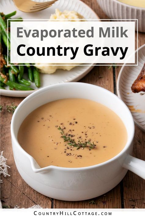 Evaporated milk gravy is rich, smooth, and ultra-creamy. The recipe is easy to make with a handful of ingredients and tastes delicious with sausage and biscuits, roasted turkey, steak, fried chicken, mashed potatoes, and more! Evaporated milk may seem a strange addition to gravy. But if you enjoy Southern cuisine, you know biscuits and sausage gravy. This delicious dish uses evaporated milk to create a rich and thick gravy with a velvety mouthfeel and creamy texture. | CountryHillCottage.com Southern Fried Steak And Gravy, Recipes Using Evaporated Milk, Milk Gravy Recipe, Sausage And Biscuits, Fried Chicken Mashed Potatoes, Savory Hand Pies Recipes, Brown Gravy Recipe Easy, Country Gravy Recipe, Biscuits And Sausage Gravy