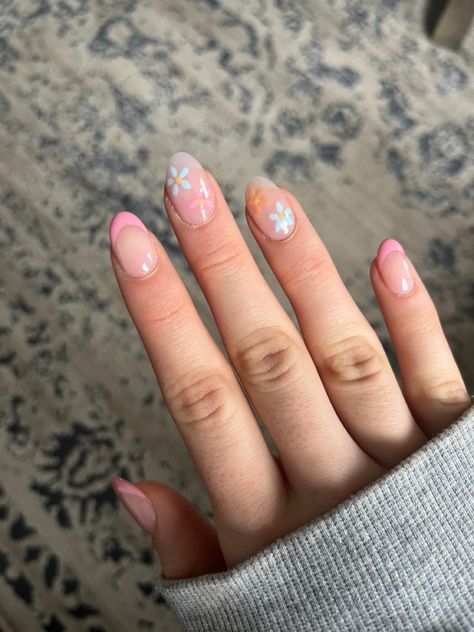 pink french tip nails with 2 blue and orange flowers Spring Time French Tip Nails, Colorful French Tip Nails With Flowers, Spring Nails 2024 Short Almond, Floral Nails French Tip, Coastal Nails Almond, Spring Birthday Nails Almond, Spring Nail Sets Almond, Vacay Nails Short, Pink And Blue Almond Nails