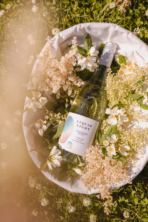 Summer wine vibes, wildflowers bring out vibrance in Sauvignon Blanc Wine Brand Photography, Summer Wine Photography, Wine Campaign Ideas, Winery Aesthetics, Wine Product Photography, Wine Styling, Wine Vibes, Wine Photoshoot, Flowers And Wine