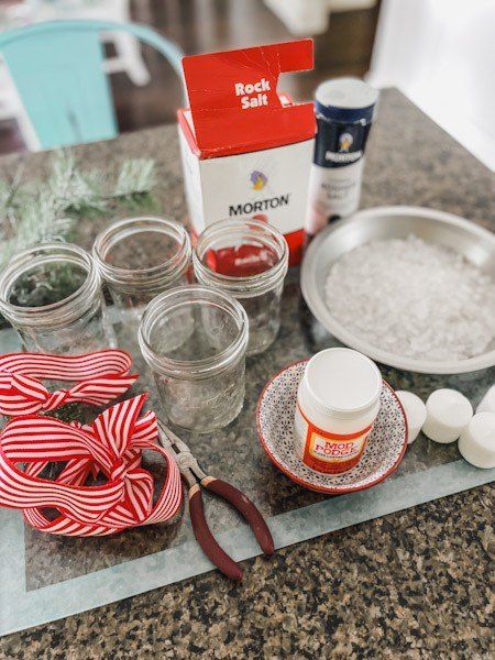 Easy directions on how to make a snowy mason jar candle holderHere is the quickest way to make a pretty Christmas centerpiece. These snowy mason jar candle holders are so easy to make using Mod Podge for the holiday season. The snowy frosted look is made with kosher salt! I know how inexpensive can you get creating a DIY Christmas candle holder?I am not only going to use them as my Christmas centerpiece but I am also going to put them outside on the porch leading up to the front door a… Christmas Candle Holders Diy, Jar Candle Holders, Frosted Candle Holders, Christmas Candles Diy, Christmas Candle Holder, Mason Jar Candle Holders, Live Christmas Trees, Jar Candle Holder, Christmas Candle Holders