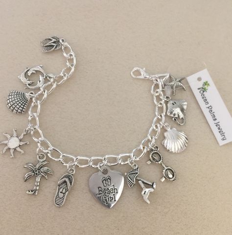 Love the beach bracelet full of beach charms. View at Ocean Palms Jewelry Ocean Charm Bracelet, Beach Silver Jewelry, Beach Charm Bracelet, Beach Bracelets, Mens Silver Necklace, Girl Jewelry, Silver Jewellery Sets, Silver Charm Bracelet, Love Charms