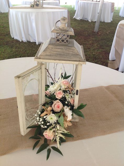 Lantern With Flowers Centerpieces, Flowers In Lanterns Centerpieces, Lantern Flower Arrangements, Lantern Flower Centerpiece, Lantern Flowers, Wedding Lantern Decor Reception Ideas, Lantern With Flowers, Lantern Floral Arrangements, Lantern Centerpieces With Flowers