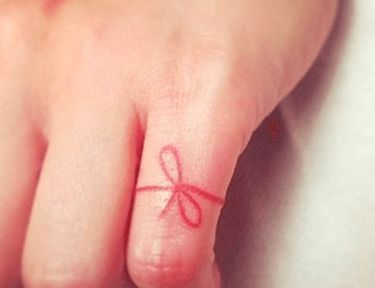 Why People Are in Love With Red String Tattoos | TipHero Red String Finger Tattoo, Red Ribbon Tattoo Meaning, Red Flag Tattoo, Red String Of Fate Drawings, Red Thread Tattoo, Red String Of Fate Tattoo, Invisible String Tattoo, Red String Tattoo, String Tattoo