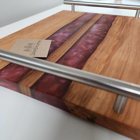 Natural Cherry Live Edge w/ Black Walnut Stripe w/ Red Diamond Savage Swirl & Nickel Handles. Wow!! Finished w/ Howard’s Oil. LG 11” x 14”. Beautiful Silky Wood... DM or see more selections at @maximus_home In Old Saybrook. ————— #charcuterieboard #charcuterie #epoxyart #epoxy #epoxyresin #epoxywood #epoxyresinart #epoxyresincrafts #epoxyriver #resinart #resincraft #resintray #wowfactor #epoxyart #cuttingboard #aluminum #riverTray #liveedge #diamond #liveedgewood #epoxyideas #entertain #s... Epoxy Resin Crafts, Epoxy Resin Art, Live Edge Wood, Red Diamond, Wow Factor, Black Walnuts, Black Walnut, Live Edge, Resin Crafts