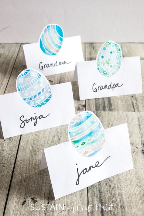 Simple DIY printable Easter place cards | Easy and beautiful watercolor Easter egg name card ideas | #tablescape #easterdecor #watercolor #spring #printable Easter Name Place Cards, Easter Name Place Settings, Easter Place Setting Ideas Name Cards, Easter Table Place Cards, Easter Place Settings Diy, Easter Table Name Cards, Easter Place Settings Name Cards, Easter Place Cards Ideas, Easter Name Tags Place Settings