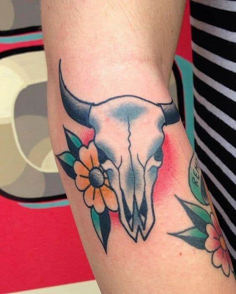 Most tattoos have beautifully hidden meanings. Bull tattoos always represent aggressiveness. If you are someone with a never die attitude, who is ready to fight, this is a perfect tattoo idea for you. The fighting spirit is amazingly expressed on this tattoo.  #tattoofriday #tattoos #tattooart #tattoodesign #tattooidea Cow Skull Tattoo, Cow Skull Tattoos, Bull Skull Tattoos, Cow Tattoo, Bull Tattoos, Western Tattoos, Traditional Tattoo Sleeve, Theme Tattoo, Tattoo Traditional