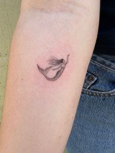 17 Magical Little Mermaid Tattoo Ideas for a Fantastical 2024 - Get Inspired Now! Mermaid Fineline Tattoo, Tiny Mermaid Tattoo Simple, Tiny Mermaid Tattoo, Little Mermaid Tattoo Ideas, Simple Mermaid Tattoo, Mermaid Tattoo Ideas, Small Mermaid Tattoo, Max Tattoo, Ariel Tattoo