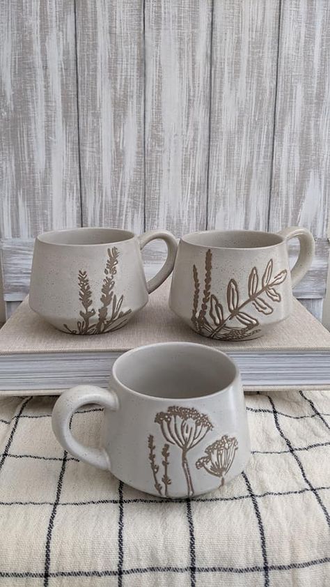 The prettiest mug for Fall! Matte cream 100% stoneware mug in 3 different styles: Willow, Fern, or Wildflower design. Holds 10 oz. Has slight beige speckles scattered for an antiqued look. Each sold separately. 4.25" round, 3.25" high Cottage Mug, Wildflower Mug, As You Wish Pottery Ideas, Pottery Mug Designs, Beautiful Kitchenware, Boho Mug, Pretty Mug, Wildflower Design, Pretty Mugs