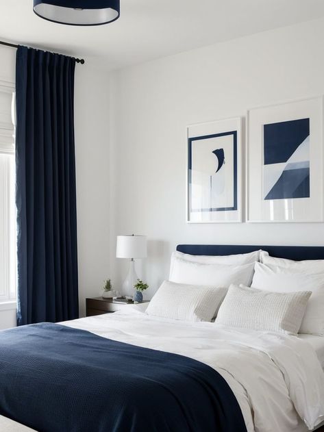 Create a bold statement by painting one wall navy blue and hang a gallery wall of artwork to add a personalized touch. Pair it with a sleek white bed frame and minimalist furniture for a modern and stylish look. Navy Blue Minimalist Bedroom, Navy Blue And White Room Bedrooms, Minimalist Bedroom Blue And White, Bedroom With Navy Bed, Navy Blue And White Bed, White And Dark Blue Bedroom, Navy Blue Walls Bedroom, Navy Bed Frame, Minimalist Bedroom Blue