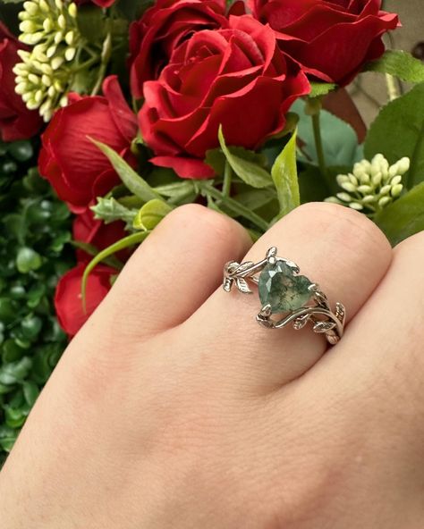 Mother Earth - heart shaped moss agate ring with a leaf and vine band 🍃 Beautiful ring straight out of an enchanted forest in a fairytale 🌹 #mossagatering #mossagate #mossagatejewelry #heartring #fantasyring #fantasyjewelry #fairycore #fairytalejewelry #mossagateheart #crystalring #uniquering #gemstonering #lovering #promisering #selflovejewelry #natureinspiredjewelry #enchantedwedding #ringinspo #ringinspiration #leafring #leafband Enchanted Forest Wedding Theme, Nontraditional Engagement Rings, Fairy Tale Jewelry, Moss Agate Jewelry, Forest Theme Wedding, Crystal Bouquet, Fantasy Ring, Earthy Wedding, Fairy Ring