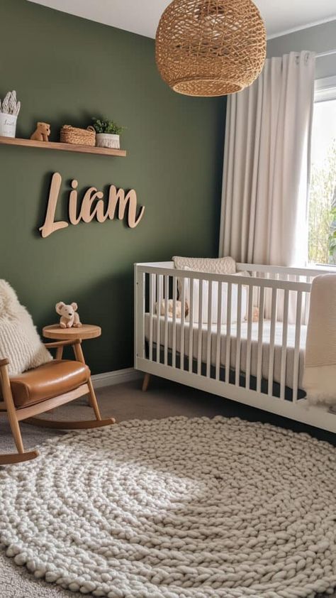 Modern earthy baby boy nursery with deep green walls, a personalized wooden name sign, and cozy textures. Sage Green Shiplap Wall Nursery, Hunter Green Nursery Gender Neutral, Nursery Light Green Walls, Forest Green Accent Wall Nursery, Sage Green Jungle Nursery, Nursery With Green Crib, Grey And Sage Nursery, Dark Green Girl Nursery, Boy Nursery Green Accent Wall