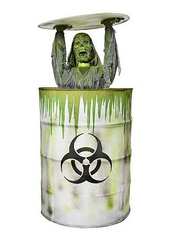 Not to be confused with the 2010 animatronic Zombie Barrel. The Toxic Zombie was an animatronic sold by Spirit Halloween for the 2008 Halloween season. It resembled a melting green zombie dwelling inside a toxic waste barrel. When activated, the zombie rose from the barrel, while lifting the lid over its head. As this occurred, groaning and screaming could be heard, while green lights would illuminate the interior of the barrel and its head turned as its eyes lit-up. “Toxic Zombie is the stuff Zombie Yard Decorations, Toxic Waste Barrel, Spirit Halloween Animatronics, Green Zombie, Halloween Spirit Store, Halloween Animatronics, Halloween Costume Store, Toxic Waste, Halloween Scarecrow