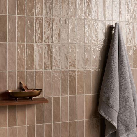 Refresh any space with our Portmore Taupe 3x8 Glazed Ceramic Tile, a versatile, classic subway in a go-to neutral shade that suits any design style. Portmore’s appearance—speckled, uneven, and artisanal—lends it a rustic, yet sophisticated vibe. With its subtle, Moroccan influence, this glazed tile will transform your residential or commercial walls with long-lasting, statement-making beauty. The Portmore collection of glazed, ceramic tiles is inspired by the colors and exquisite tilework found Tan Bathroom Tile Ideas, Tile With Bathtub, Brown Shower Tile Bathroom, Mauve Tile Bathroom, Organic Bathroom Tile, Beige Subway Tile Bathroom, Clay Tile Bathroom, Mid Century Shower Tile, Tan Quartz Countertops