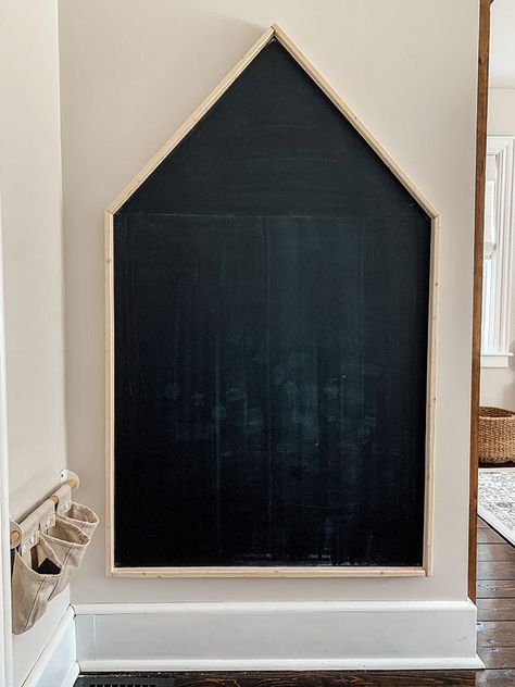 Simple step-by-step tutorial on how to make an oversized DIY magnetic chalkboard in the shape of a house. It is perfect for a playroom! DIY giant chalkboard. Diy magnetic chalkboard for kids. House Chalkboard. Diy House Chalkboard, Chalkboard House Wall, Diy Chalkboard Wall Playroom, Chalkboard In Playroom, Playroom With Chalkboard Wall, House Shaped Chalkboard, House Chalkboard Ideas, Chalk Paint Wall Kids Room, House On Wall Playroom