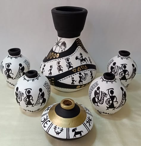 Hand-painted miniature pots with warli art Warli On Pot, Warli Art Designs On Pots, Traditional Pot Painting, Worli Painting On Pot, Warli Paintings On Pots, Warli Art On Pots, Pot Painting Ideas Creative Indian, Matki Painting, Miniature Pots