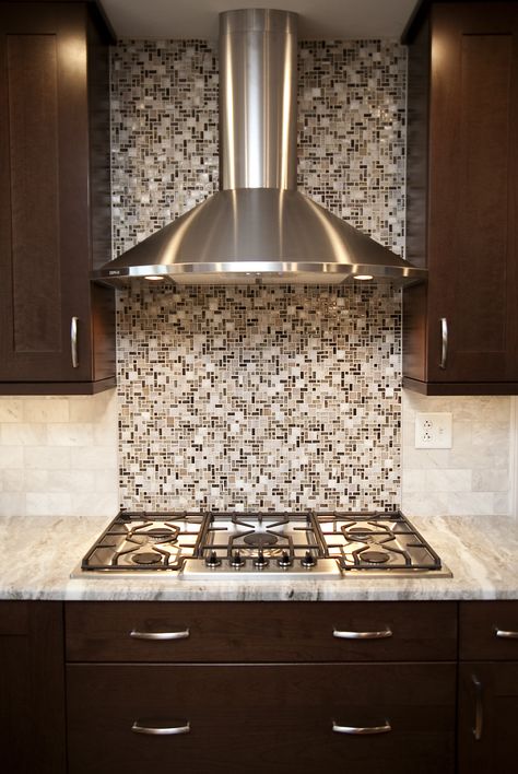 Transitional Naperville kitchen remodel. Beautiful stainless hood highlights the cooktop area along with glass mosaic backsplash tile. Glass Range Hood Kitchen, Cooktop Backsplash Ideas, Kitchen Highlighter Tiles, Glass Range Hood, Cabinetry Kitchen, Oven Hood, Decorative Backsplash, Quartz Backsplash, Ideas Cocina