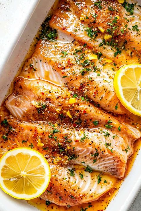 Garlic Butter Oven-Baked Tilapia - Insanely Good Thai Tilapia Recipes, Fish In The Oven Recipes, Tilapia Filets Recipes, Tilapia Marinade Recipes, Baked Swai Fish Recipes Ovens, Baked Talipia Recipes Ovens, Low Fat Fish Recipes, Baked Tilapia Recipes Oven, Basa Recipes