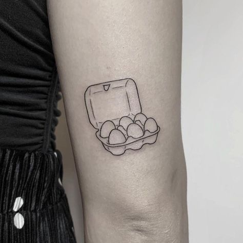 Egg carton or egg tray tattoo inked above the right elbow by @hellotako Cracked Egg Tattoo, Deviled Egg Tattoo, Egg Tattoo Ideas, Ignorant Tattoo Ideas, Fried Egg Tattoo, Easter Egg Tattoo, Breakfast Tattoo, Egg Tattoo, Cooking Tattoo