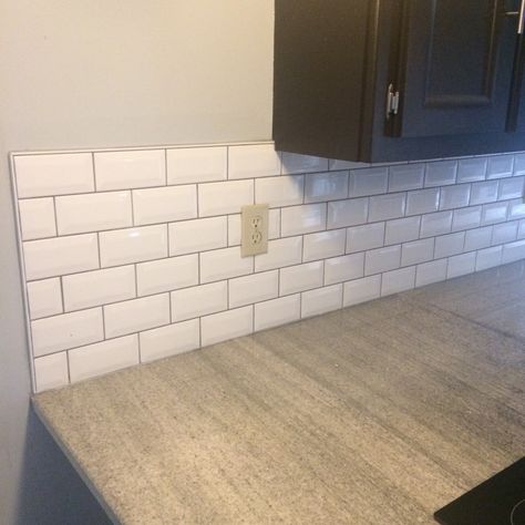 Bright white bevel subway tile with dark grey grout. Very happy with the result. Completely changes the look of my kitchen. White Tile Grey Grout Kitchen, Utility Tiles, White Kitchen Tiles Grey Grout, Grey Tile Grout, White Tiles Grey Grout, Black Home Design, Beveled Subway Tile Backsplash, Tile Grout Color, White Beveled Subway Tile