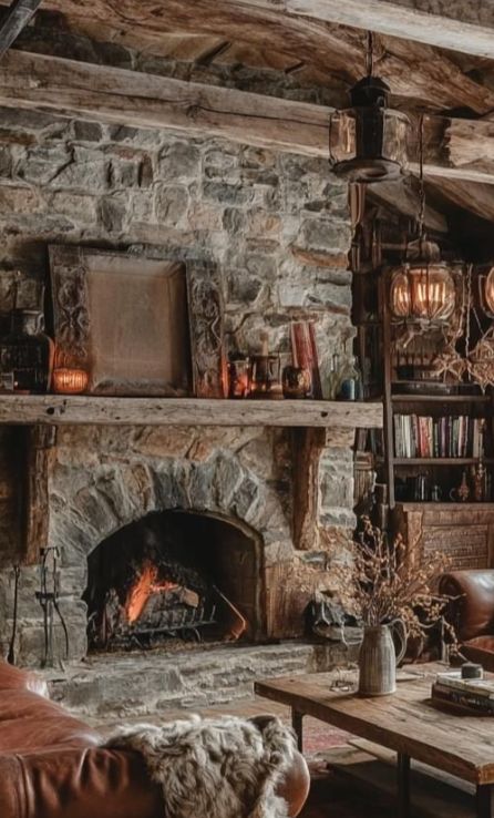 Moody Living Room With Stone Fireplace, Brick Fireplace Dark Walls, Walk In Fireplace Hearth, Stone Fireplace Cottage, Yellowstone Fireplace, Stone Fireplace Bookshelves, Moody Stone Fireplace, Rock Fireplace Mantle, Rustic Rock Fireplace