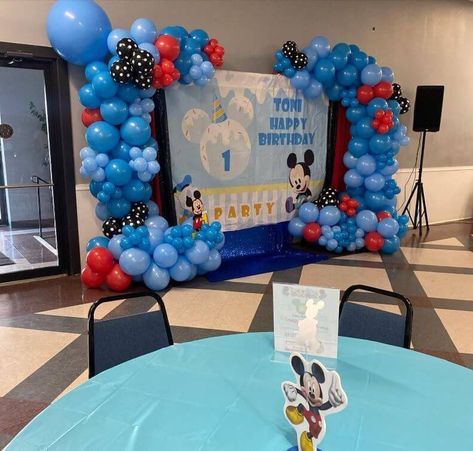 WOW, your guests by setting up a highly adorable Mickey Mouse birthday party backdrop and celebrate your little lad’s 1st birthday in a fun-filled way. Set the backdrop by fixing a customized Mickey Mouse birthday banner and hang black, red, and blue sequin curtains on the backdrop stand along with a cheerful balloon garland featuring red, blue, and black & white polka dot balloons. Spread serenity blue disposable tablecloths atop the party tables and ooze fun and festive vibes all around. Mickey Mouse Birthday Banner, Mickey Mouse 1st Birthday Party, Sequin Curtains, 1st Birthday Party Decor, Party Decorations Table, Polka Dot Balloons, Mickey Mouse 1st Birthday, Dream Setup, Home Decor Photography